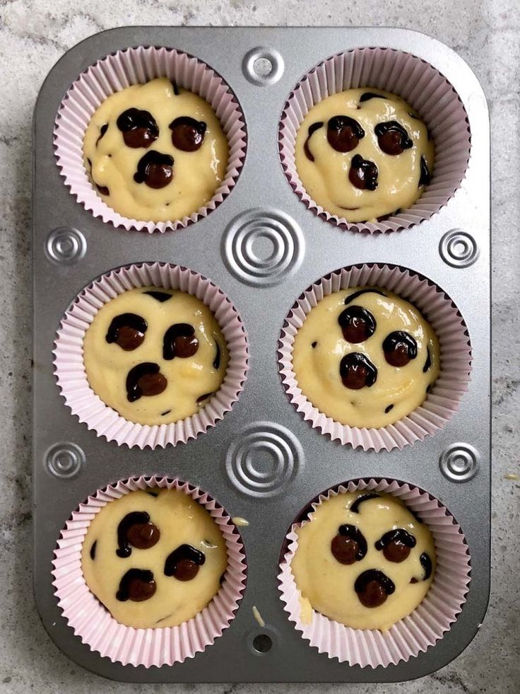 some cupcakes are sitting in a muffin tin