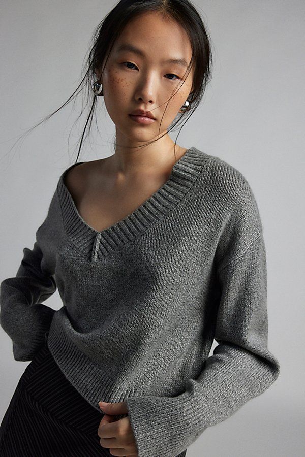 Forever staple BDG sweater in an effortless pull-over style. Designed in a boxy & cropped fit featuring a wide v-neckline and drop shoulders for a slouchy look. Finished with ribbed knit trim. Find it only at Urban Outfitters. Features BDG Jenna v neck sweater Slouchy sweater Soft and stretchy knit Wide v-neckline and long sleeves with ribbed knit trim Ribbed knit hem Boxy, relaxed fit Cropped length Easy pull-over style UO exclusive Contents + Care 53% Recycled polyester, 47% polyester Machine Star Headband, Slouchy Sweater, Leather Trench Coat, Shearling Coat, Velvet Tops, Pullover Jacket, V Neck Sweater, Grey Sweater, Vneck Sweater