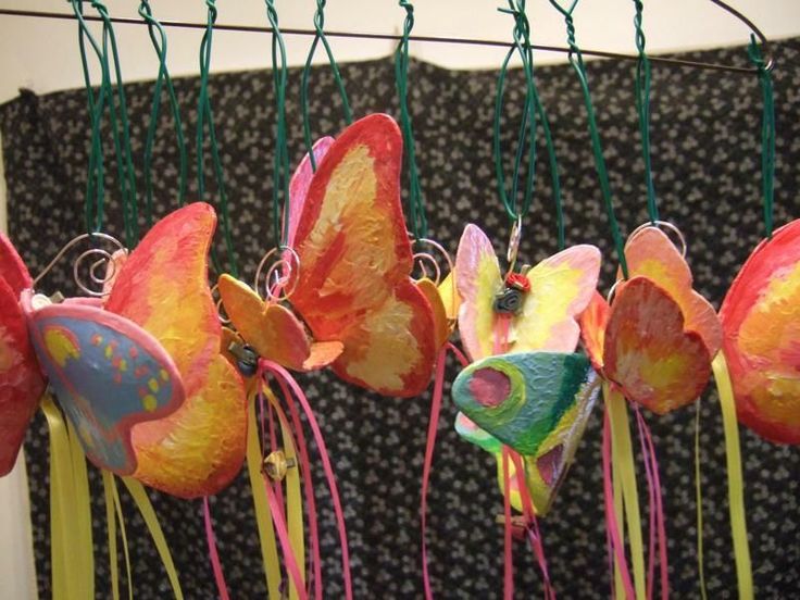 colorful paper flowers are hanging from a wire