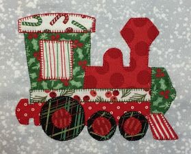 a christmas train machine appliqued on a gray background with snowflakes