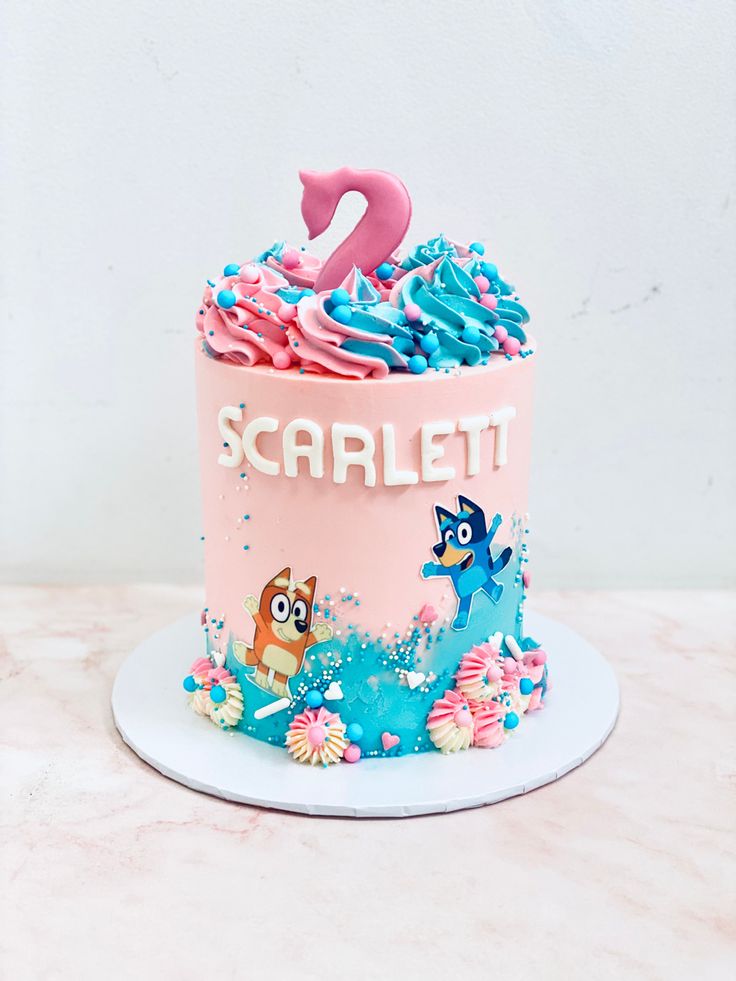 a pink and blue cake with the number two on it