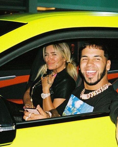 two women and a man sitting in a yellow car