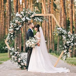 a bride and groom standing in front of a wooden arch with flowers on the side