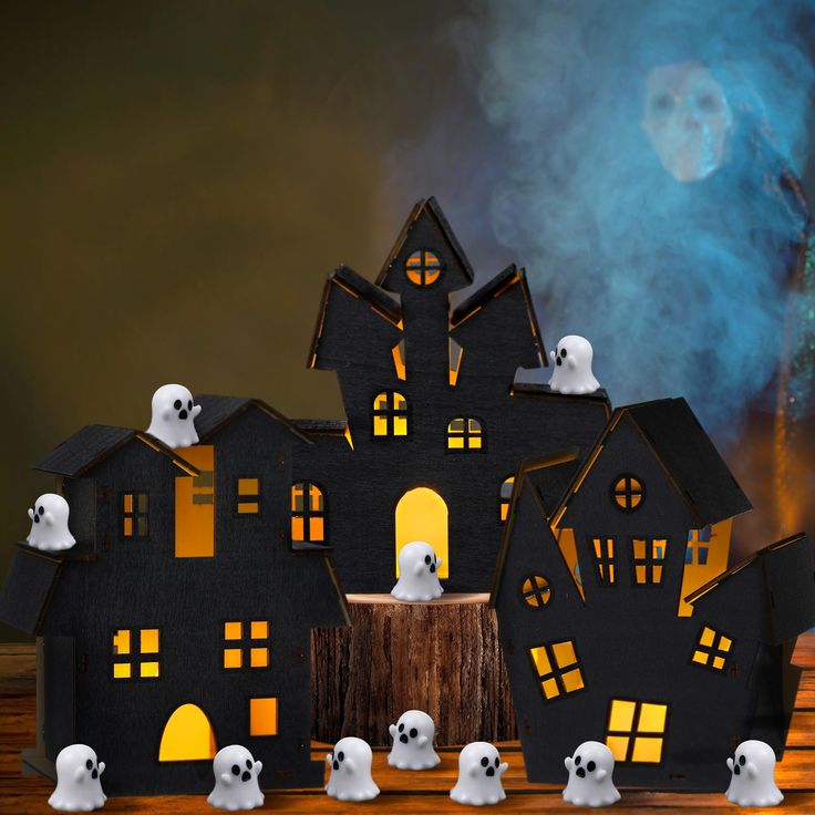 a group of halloween ghost figures in front of a black house with glowing windows and pumpkins