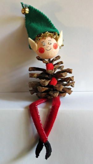 a pine cone elf ornament hanging on a wall