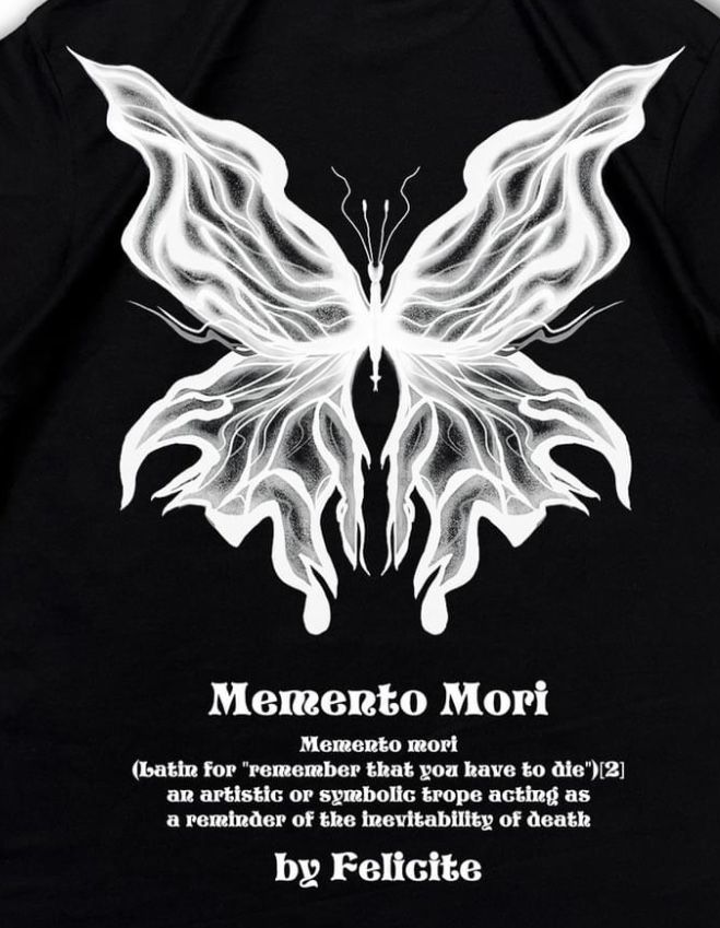 the back of a black shirt with a white butterfly on it's chest and words written