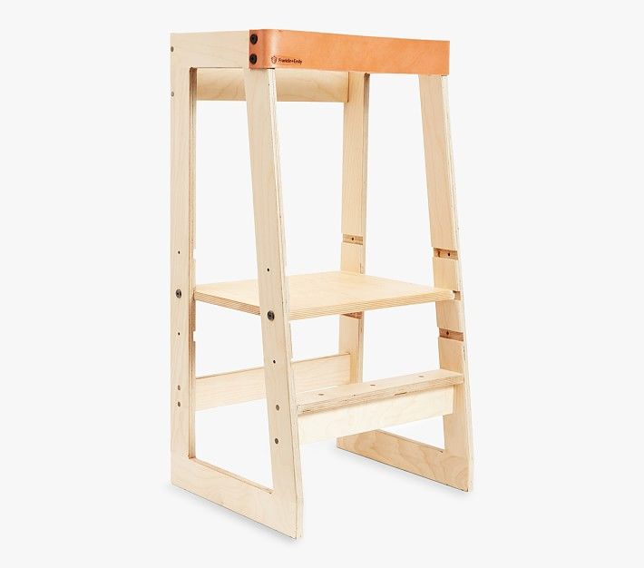 a wooden step stool sitting on top of a white floor next to an open shelf