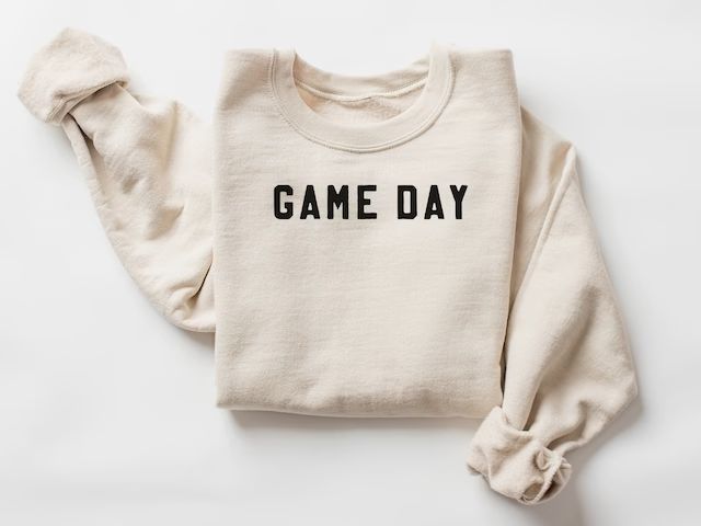 a white sweatshirt with the words game day printed on it