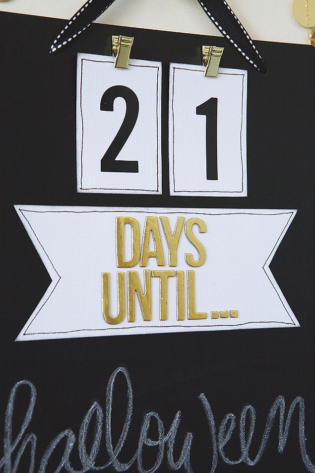 a black and white sign that says 21 days until halloween hanging on a wall with gold lettering