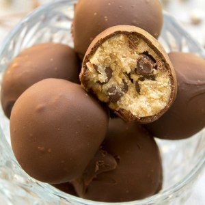 a glass bowl filled with chocolate candies on top of a table