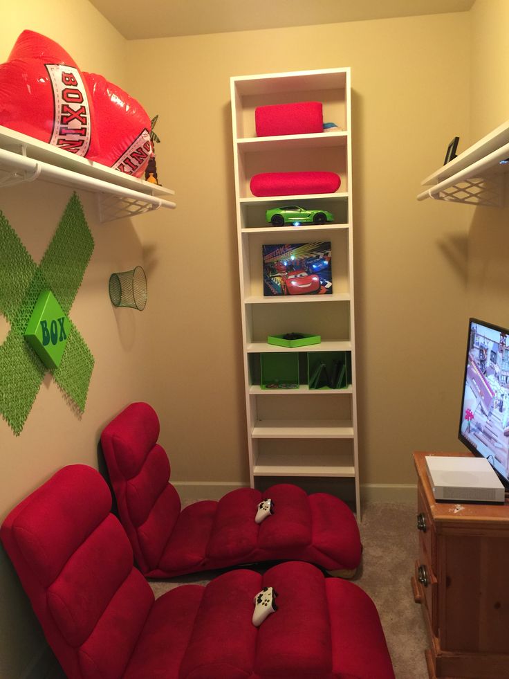 a red recliner chair sitting in front of a tv