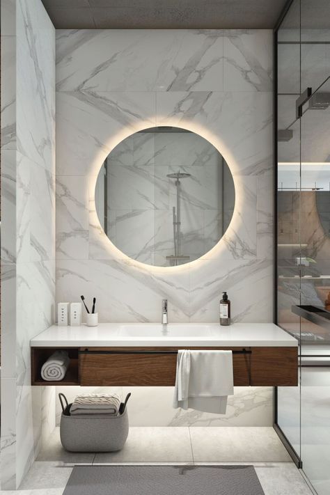 a bathroom with a round mirror above the sink