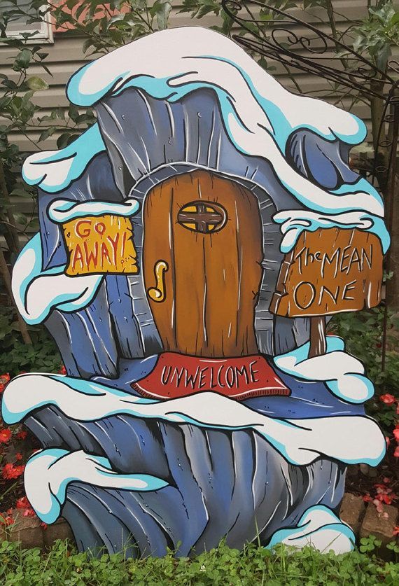 a wooden sign that says welcome to an animal one in front of some bushes and flowers