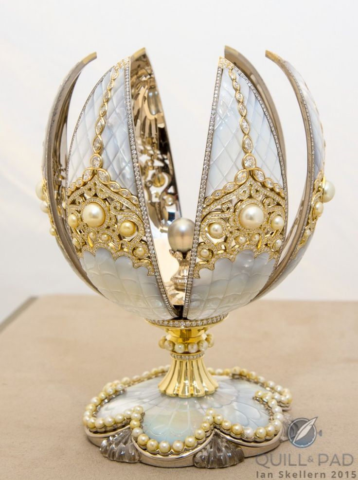 an elaborately decorated egg with pearls on it