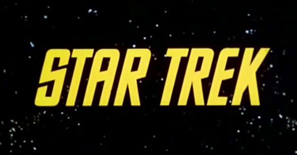 the title for star trek, written in yellow on a black background with stars around it