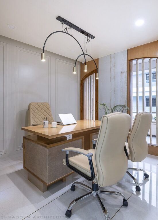 an office with a desk and chairs in it