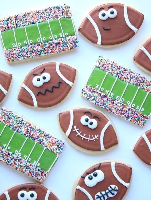 decorated cookies with footballs and sprinkles are arranged on a white surface