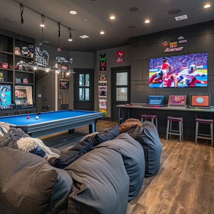 Fun Game Room in Simone Biles' Texas Home Sports Family Room, Basement Movie And Game Room, Sport Living Room, Media Room With Pool Table, Console Game Room, House Game Room, Living Room Game Room Combo, Console Gaming Room, Game Room Mansion