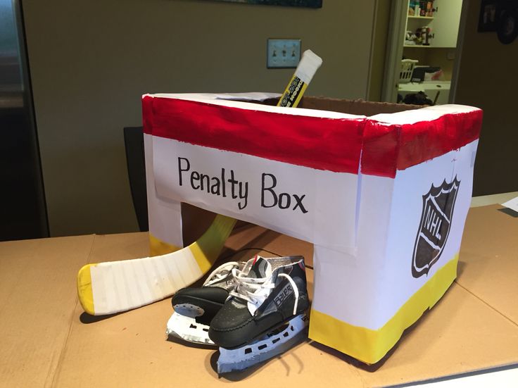 there is a box that has some hockey shoes in it on the table next to an ice skates