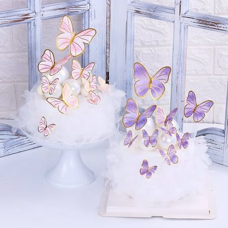 two cakes with butterflies on them sitting next to each other