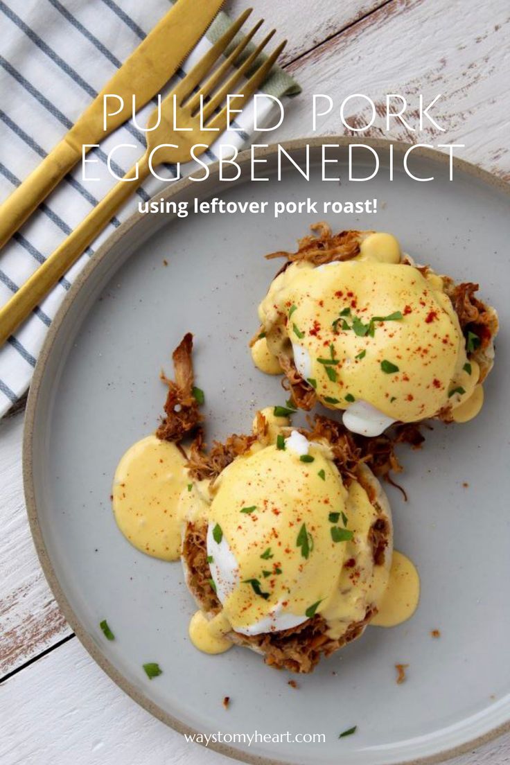 two eggs benedicts are sitting on a plate with fork and knife next to it