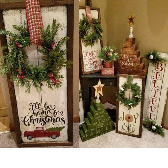 christmas decorations are displayed on the floor in front of a mirror and two wooden signs