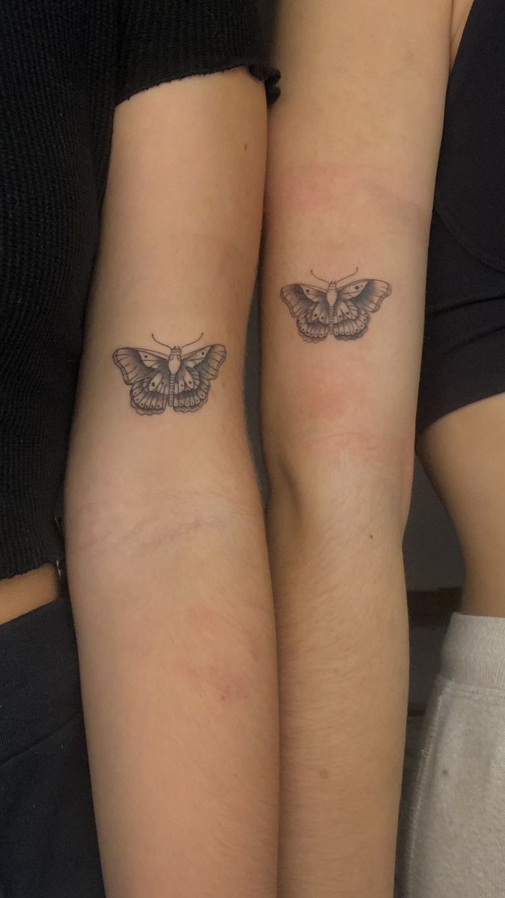 two people with matching tattoos on their arms