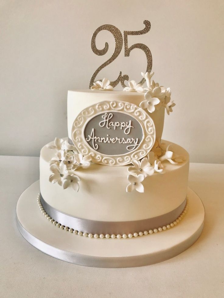 a white wedding cake with silver decorations and the number twenty five on it's side