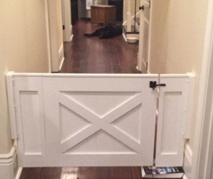 a dog laying on the floor in front of a white door with an open side panel