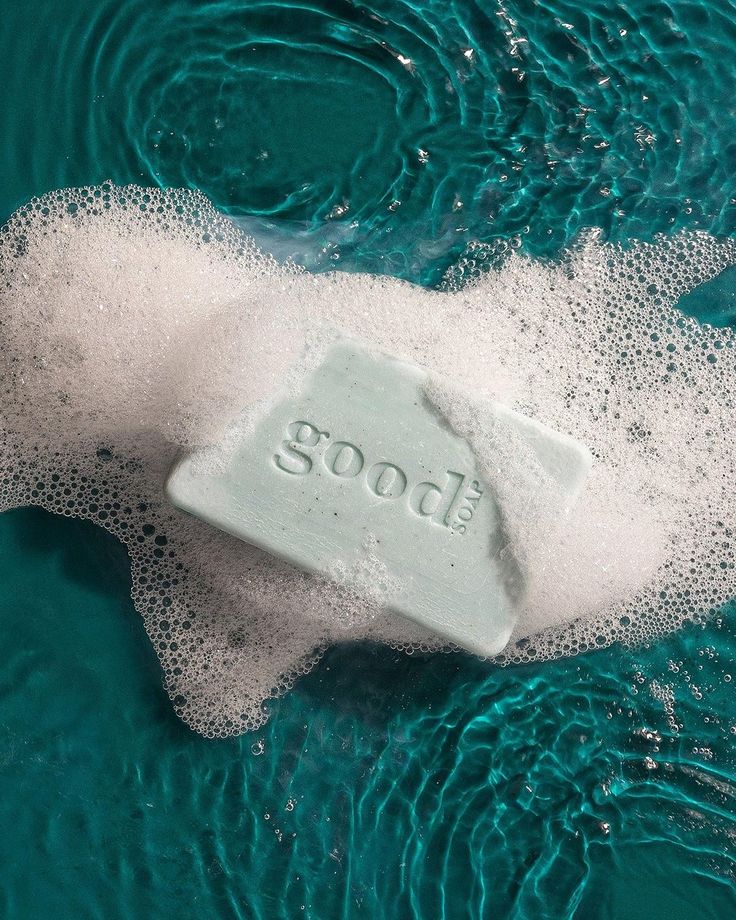 soap on top of water with bubbles in the middle and word soot above it