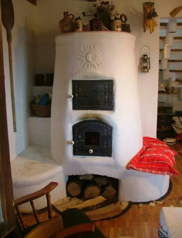 a living room with a large white stove in the middle of it's walls