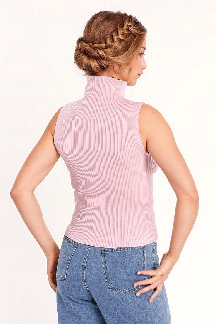 Introducing our Knitted Baby Pink Top Without Sleeves – a chic and versatile addition to your wardrobe. This pink top, featuring a high neck and sleeveless style, is designed to bring a touch of elegance to your daily attire.  The turtleneck neckline adds sophistication, while the bodycon fit ensures a flattering silhouette that seamlessly complements various outfits. Whether you choose to wear it alone or pair it with a blazer, this top is a versatile piece for your daily wardrobe.  Crafted from fine knit with a composition of 55% Viscose and 45% Polyamide, this top offers a soft and comfortable feel against your skin. The model is showcasing the size S, and with her measurements (33-24-35, Height: 5'9''), you can visualize the stylish fit of this top.  Please note that this top runs smal Pink Ribbed High Neck Top, Spring Turtleneck Stretch Tank Top, Spring Stretch Turtleneck Tank Top, Stretch Turtleneck Tank Top For Spring, Chic Pink Ribbed Tank Top, Chic Ribbed Funnel Neck Top, Pink Fitted Fine Knit Top, Chic Stretch Knit Mock Neck Top, Chic Fitted Sweater Vest