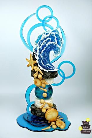 a blue and white figurine with an ocean theme