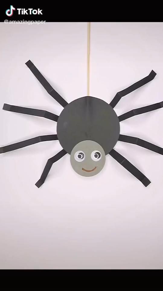 a paper spider hanging from a string