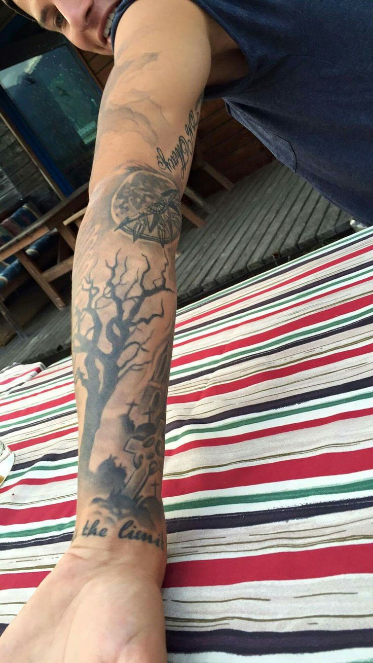 a man with a tree tattoo on his arm