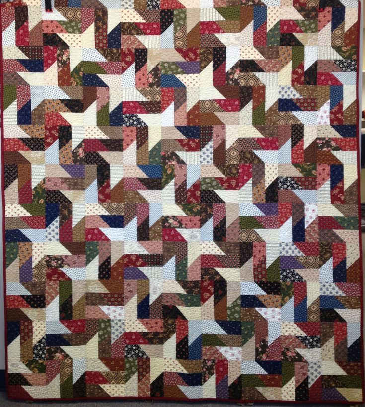 a quilt made with different colors and shapes