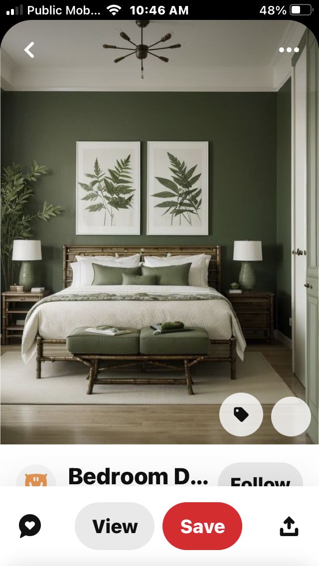 a bed room with green walls and pictures on the wall