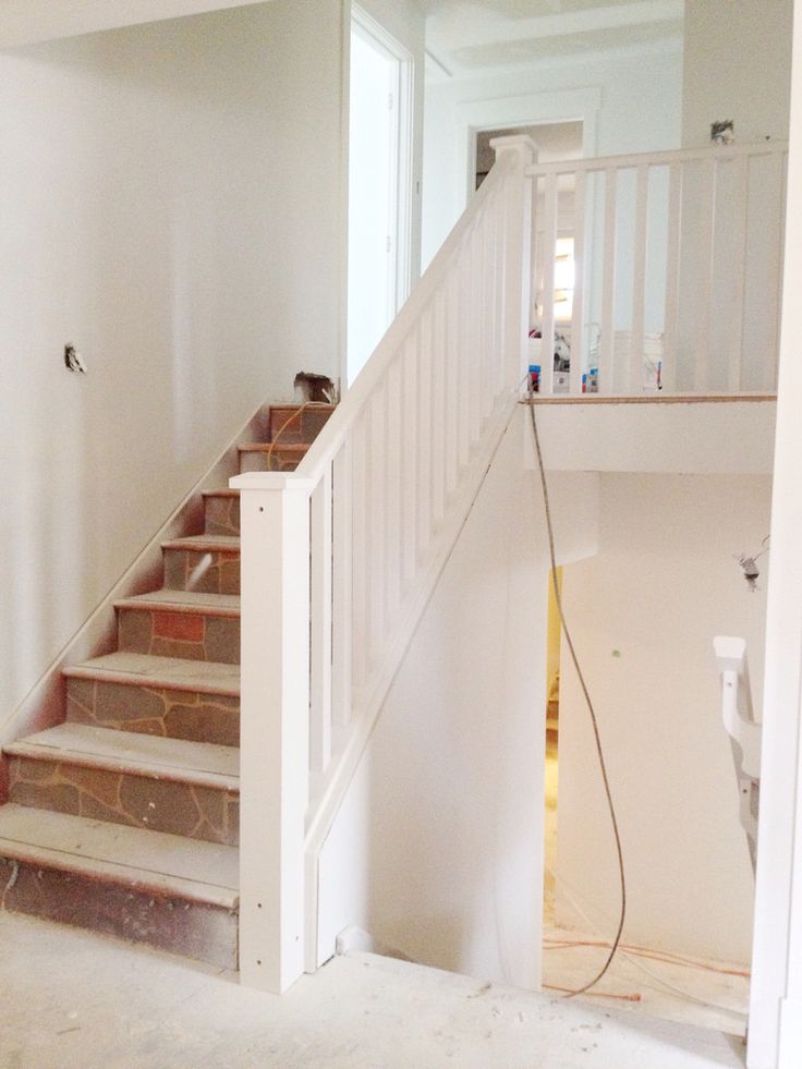 an empty room with stairs leading up to the second floor