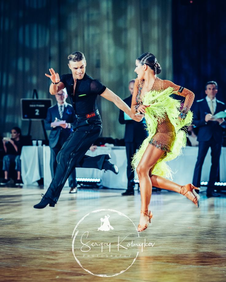 two people are dancing on a dance floor