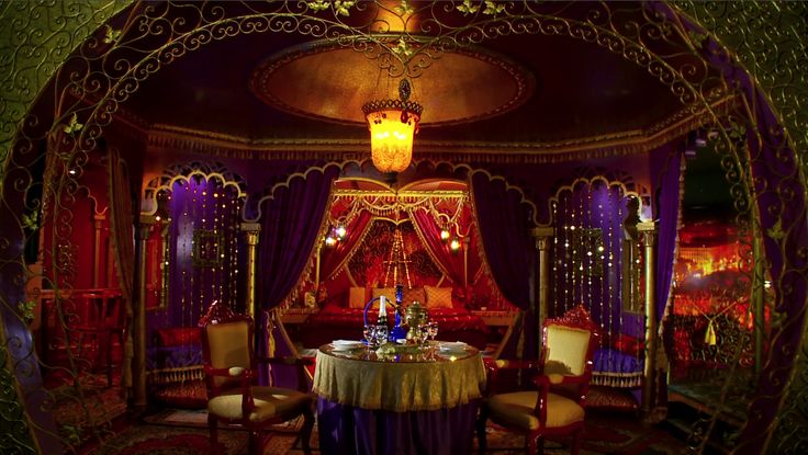 an elaborately decorated dining room with purple curtains