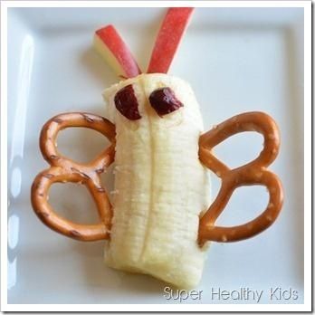 a plate with some pretzels in the shape of a banana and an apple