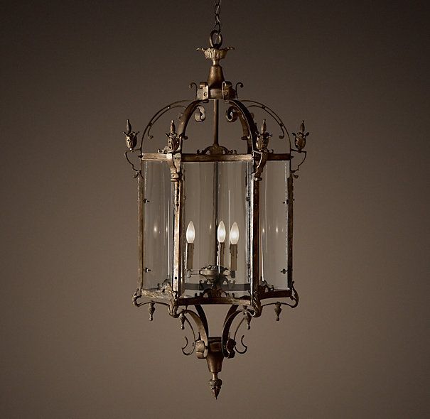 an old fashioned chandelier hanging from the ceiling