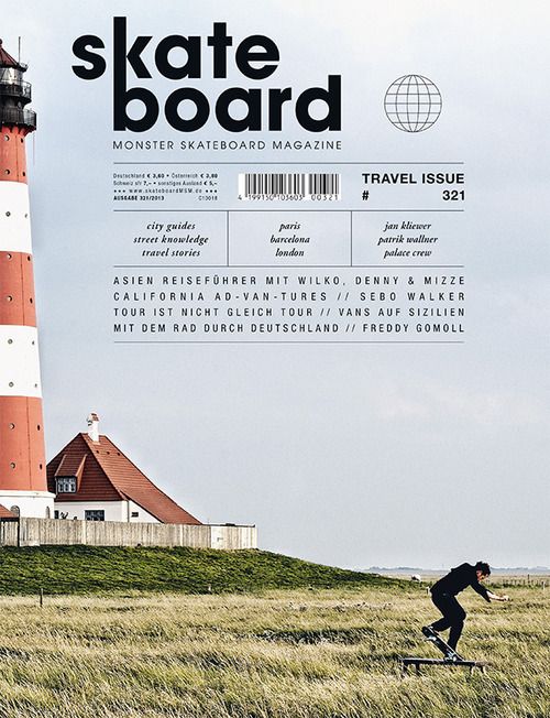 a man riding a skateboard on top of a grass covered field next to a light house