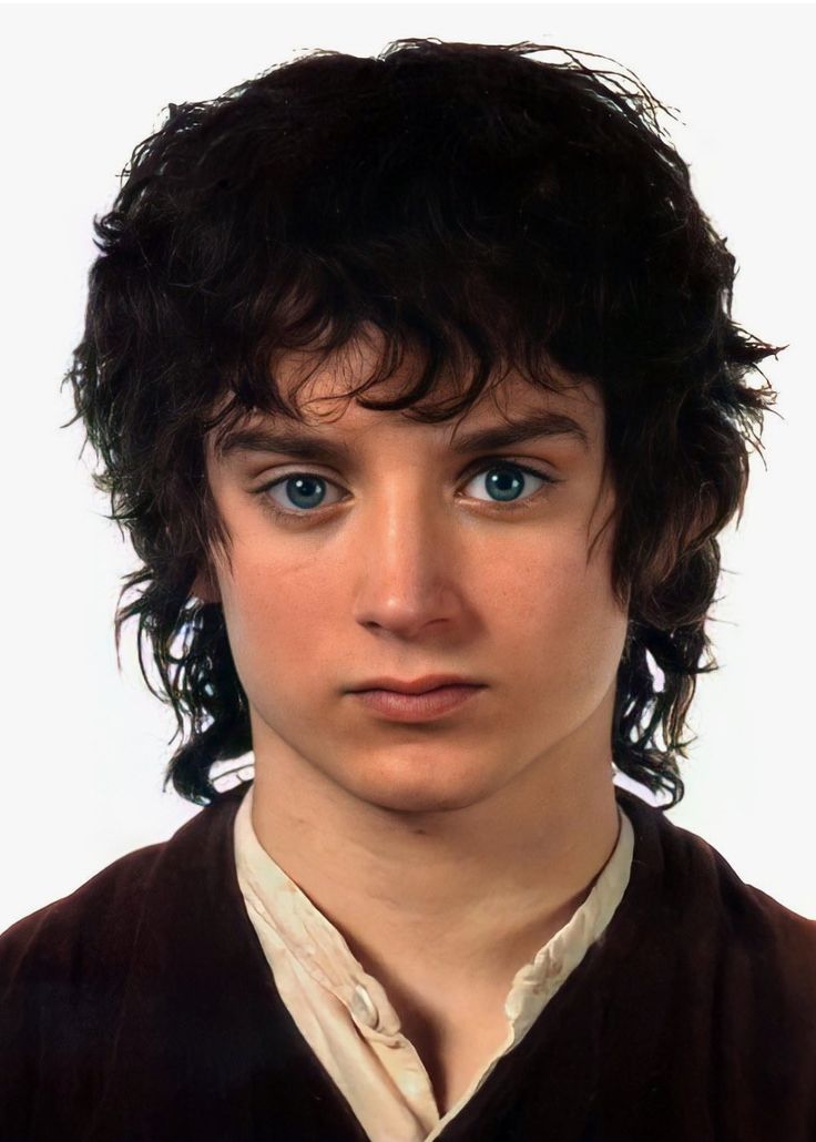 a close up of a person with curly hair and blue eyes wearing a brown vest