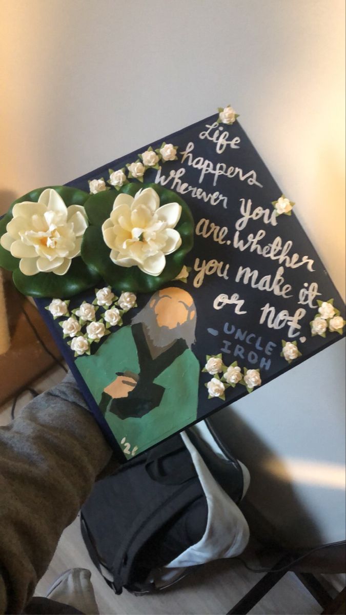 a decorated graduation cap with flowers on it