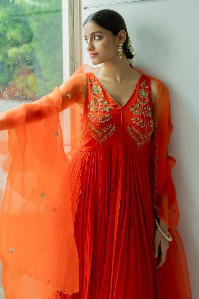 Royal orange georgette anarkali with zardosi hand embroidered yoke. Comes with a silk organza dupatta.
Components: 2
Pattern: Hand embroidered
Type Of Work: Zardosi
Neckline: V Neck
Sleeve Type: Sleeveless
Fabric: Anarkali : Georgette, Dupatta : Silk organza
Color: Orange
Other Details: 
Disclaimer : The product will dispose off some color, since it is hand dyed.
Occasion: Sangeet - Aza Fashions Orange Embroidered Georgette Sharara, Embroidered Orange Georgette Sharara, Unstitched Orange Anarkali Set For Festive Occasions, Designer Orange Salwar Kameez With Gota Work, Designer Orange Dupatta For Festivals, Orange Silk Salwar Kameez For Wedding, Orange Organza Sharara For Festivals, Semi-stitched Orange Salwar Kameez With Zari Work, Semi-stitched Orange Churidar With Zari Work