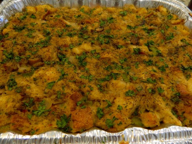 a casserole dish with meat, cheese and herbs in it on a table