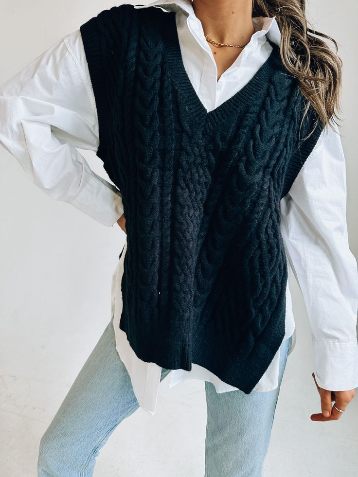 DETAILS: Our Knitted Oversized Vest has a soft and cozy knitted fabric that has an oversized fit. There is a deep v neckline that is outlined with a ribbed look. There is also a ribbed look on the hem and around the opening for the arms. There are two side slits for an open look. This vest does have an oversized look but fits true to size and our model is wearing a small! CONTENT & CARE: SELF: 42% Acrylic, 30% Polyester, 28% Nylon. SIZE & FIT: Model is 5'6" The model is wearing a size Small. Fit Trendy V-neck Cable Knit Cardigan, Cozy Soft Knit V-neck Sweater For Work, Trendy Knitted V-neck Sweater For Layering, Oversized V-neck Sweater For Work, Casual V-neck Cable Knit Sweater Vest, Cozy Textured Knit Sweater Vest For Fall, Chunky Knit Sweater Vest For Layering, Ribbed V-neck Sweater For Winter Loungewear, Fall Chunky Knit V-neck Sweater