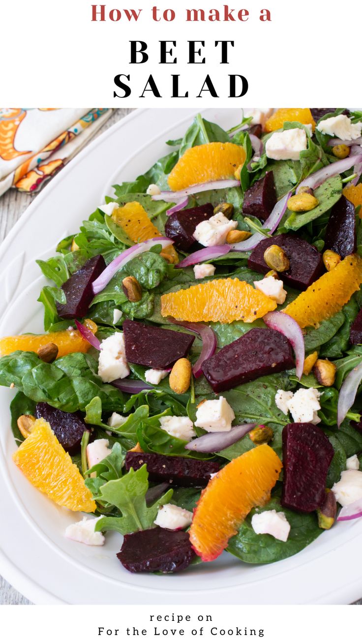 a salad with beets, oranges and goat cheese on it in a white plate