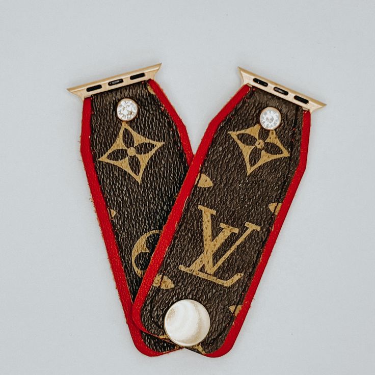 two louis vuitton brooches with diamonds on them